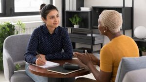 Two people practicing active listening in a professional coaching room