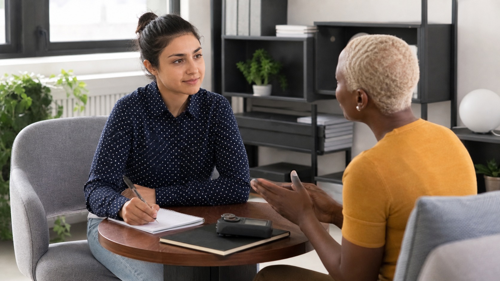 Two people practicing active listening in a professional coaching room